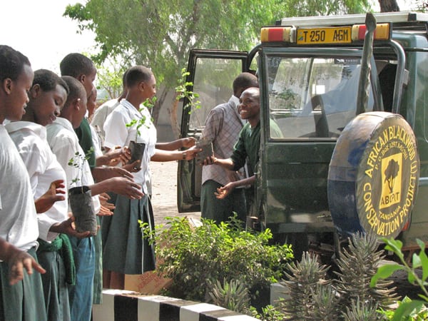 Students at Kikatiti Secondary School near Arusha line up to get mpingo seedlings for replanting on school grounds