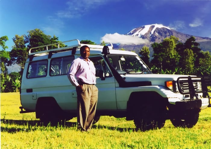 Sebastian poses with Toyota Landcruiser purchased with Rolex Award endowment