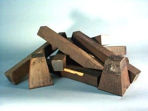 A stack of reject blanks from the musical instrument trade. 90% of the mpingo cut for this purpose ends up on the scrap pile. Some is diverted to native carvers for their use and others like these pieces are sold as imperfect pieces for other woodworking purposes such as woodturning, ornamental turning and knife handles.