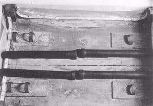Underside of portable chest, showing the blackwood carrying poles held in place by rings.